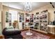 Chic closet space with built-in shelving, a chandelier, and elegant seating, perfect for showcasing fashion items at 8950 Della Scala Cir, Orlando, FL 32836