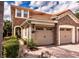 Charming two-story home with a clay tile roof, stone accents, and a brick driveway at 8950 Della Scala Cir, Orlando, FL 32836