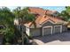 Charming home featuring a three-car garage, brick-paved driveway, and stone accents at 8950 Della Scala Cir, Orlando, FL 32836