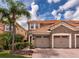 Beautiful home featuring a clay tile roof, stone accents, and a spacious two-car garage at 8950 Della Scala Cir, Orlando, FL 32836