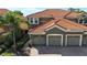 Charming home featuring a three-car garage, brick-paved driveway, and stone accents at 8950 Della Scala Cir, Orlando, FL 32836