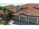 Charming home featuring a three-car garage, brick-paved driveway, and stone accents at 8950 Della Scala Cir, Orlando, FL 32836