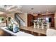 Open concept living space featuring a dining area, kitchen with bar, and staircase at 8950 Della Scala Cir, Orlando, FL 32836