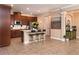 The kitchen features bar seating, dark cabinets and stainless steel appliances at 8950 Della Scala Cir, Orlando, FL 32836