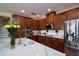 Beautiful kitchen features dark wood cabinetry, white marble countertops, and stainless steel appliances at 8950 Della Scala Cir, Orlando, FL 32836
