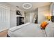 Cozy bedroom featuring neutral walls, plush carpet, a large bed, and modern lighting fixture above at 8962 Sugar Palm Rd, Kissimmee, FL 34747