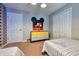 Bright bedroom featuring Mickey Mouse accents, twin beds, and playful decor for a cheerful atmosphere at 8962 Sugar Palm Rd, Kissimmee, FL 34747