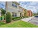 A view of a tidy front lawn and well maintained exteriors of multiple townhomes at 8962 Sugar Palm Rd, Kissimmee, FL 34747