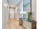 Bright hallway featuring tile flooring and a mirrored console table with decorative lamps and a green plant at 8962 Sugar Palm Rd, Kissimmee, FL 34747