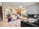 Open-concept living room features modern decor, tile floors, and adjoining dining area at 8962 Sugar Palm Rd, Kissimmee, FL 34747