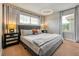 Relaxing main bedroom with geometric wallpaper, grey curtains, modern lighting, and comfortable bedding at 8962 Sugar Palm Rd, Kissimmee, FL 34747