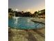Community pool featuring palm trees, waterfalls, and lounge seating, perfect for relaxing and enjoying the outdoors at 8962 Sugar Palm Rd, Kissimmee, FL 34747