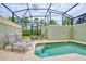 Private screened-in pool area with comfortable lounge chairs and outdoor dining set at 8962 Sugar Palm Rd, Kissimmee, FL 34747