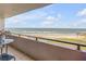 Breathtaking oceanfront balcony view showcasing the beach, waves, and expansive blue sky at 901 S Atlantic Ave # 208, Ormond Beach, FL 32176