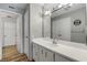 Well-lit bathroom featuring a large mirror, ample counter space, and access to additional rooms at 901 S Atlantic Ave # 208, Ormond Beach, FL 32176