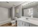 Cozy bathroom featuring wood-look floors, a tub with decorative tile, and a modern vanity with a large mirror at 901 S Atlantic Ave # 208, Ormond Beach, FL 32176