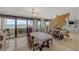 Dining area featuring a large mirror and ocean views through sliding glass doors at 901 S Atlantic Ave # 208, Ormond Beach, FL 32176