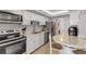 Well-lit kitchen with stainless steel appliances, white cabinetry, herringbone backsplash, and eat-in bar at 901 S Atlantic Ave # 208, Ormond Beach, FL 32176