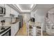 Bright kitchen features white cabinets, herringbone backsplash, and a cozy eat-in area with seating for three at 901 S Atlantic Ave # 208, Ormond Beach, FL 32176