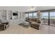 Spacious living room with custom built-ins, a sectional, and an ocean view at 901 S Atlantic Ave # 208, Ormond Beach, FL 32176