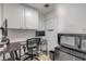 Compact office space featuring white cabinetry, desk setup, and space-saving microwave/mini-fridge combo unit at 901 S Atlantic Ave # 208, Ormond Beach, FL 32176