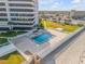 Aerial view of condo, pool, fenced yard with beach access at 901 S Atlantic Ave # 208, Ormond Beach, FL 32176