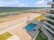 A view of the pool, ocean, and neighboring beach at 901 S Atlantic Ave # 208, Ormond Beach, FL 32176