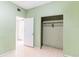 Room features tile flooring, green walls and open closet at 904 Bordeaux Pl, Orlando, FL 32808