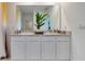 Modern bathroom featuring a double vanity, white cabinets and neutral countertops at 907 Princess Sabal Pt, Haines City, FL 33844