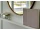 Stylish decor featuring a round mirror, books, and flowers on a shelf adding elegance to the interior at 907 Princess Sabal Pt, Haines City, FL 33844