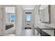 Bright foyer with a glass door and a modern table with mirror, creating a welcoming entrance at 907 Princess Sabal Pt, Haines City, FL 33844
