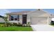 Charming one-story home with a well-manicured lawn, two car garage, and inviting curb appeal at 907 Princess Sabal Pt, Haines City, FL 33844