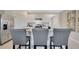 Modern kitchen with white cabinets, stainless steel appliances, and bar stool seating at 907 Princess Sabal Pt, Haines City, FL 33844