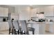 Modern kitchen with white cabinets, stainless steel appliances, and bar stool seating at 907 Princess Sabal Pt, Haines City, FL 33844