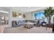 Comfortable living room with a large sectional sofa and view from a bright window at 907 Princess Sabal Pt, Haines City, FL 33844