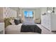 Luxurious main bedroom with a tufted headboard, accent mirrors and bright window at 907 Princess Sabal Pt, Haines City, FL 33844