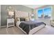 Luxurious main bedroom with a tufted headboard, accent mirrors and bright window at 907 Princess Sabal Pt, Haines City, FL 33844