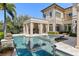 Back of house view features a luxurious pool and spa, with meticulously kept landscaping and classic architecture at 9720 Vista Falls Dr, Golden Oak, FL 32836