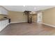 Open basement area features wood-look tile, kitchenette, and spiral staircase at 10031 Union Park Dr, Orlando, FL 32817