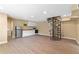 Spacious basement with wood-look tile, kitchenette, and spiral staircase at 10031 Union Park Dr, Orlando, FL 32817