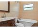 Charming bathroom featuring a claw foot tub, vanity sink, and tiled walls at 10031 Union Park Dr, Orlando, FL 32817