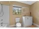 Bathroom featuring a white vanity, toilet, and shower/tub combination with a window providing natural light at 10031 Union Park Dr, Orlando, FL 32817