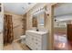 Bathroom featuring a shower with a curtain, vanity, mirror, and neutral tile flooring at 10031 Union Park Dr, Orlando, FL 32817