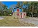 Exterior of home with a unique barn-style architecture, landscaping, and surrounding trees at 10031 Union Park Dr, Orlando, FL 32817