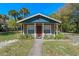 Quaint home exterior with front porch, neat landscaping, and a well-maintained yard at 10031 Union Park Dr, Orlando, FL 32817