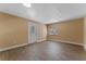 Well lit room with wood-look tile flooring, a window, and a door with glass inset at 10031 Union Park Dr, Orlando, FL 32817