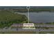 Aerial view of townhomes near a beautiful lake and greenbelt, with property locator at 10566 Green Ivy Ln, Orlando, FL 32832