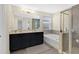 A bathroom with a double sink vanity, soaking tub, and a separate glass shower offering modern amenities at 10566 Green Ivy Ln, Orlando, FL 32832