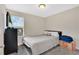 Comfortable bedroom with a neutral color palette and large window, offering a relaxing retreat at 10566 Green Ivy Ln, Orlando, FL 32832