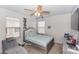 Cozy bedroom with a ceiling fan, neutral walls, a comfortable bed and a large armchair at 10566 Green Ivy Ln, Orlando, FL 32832